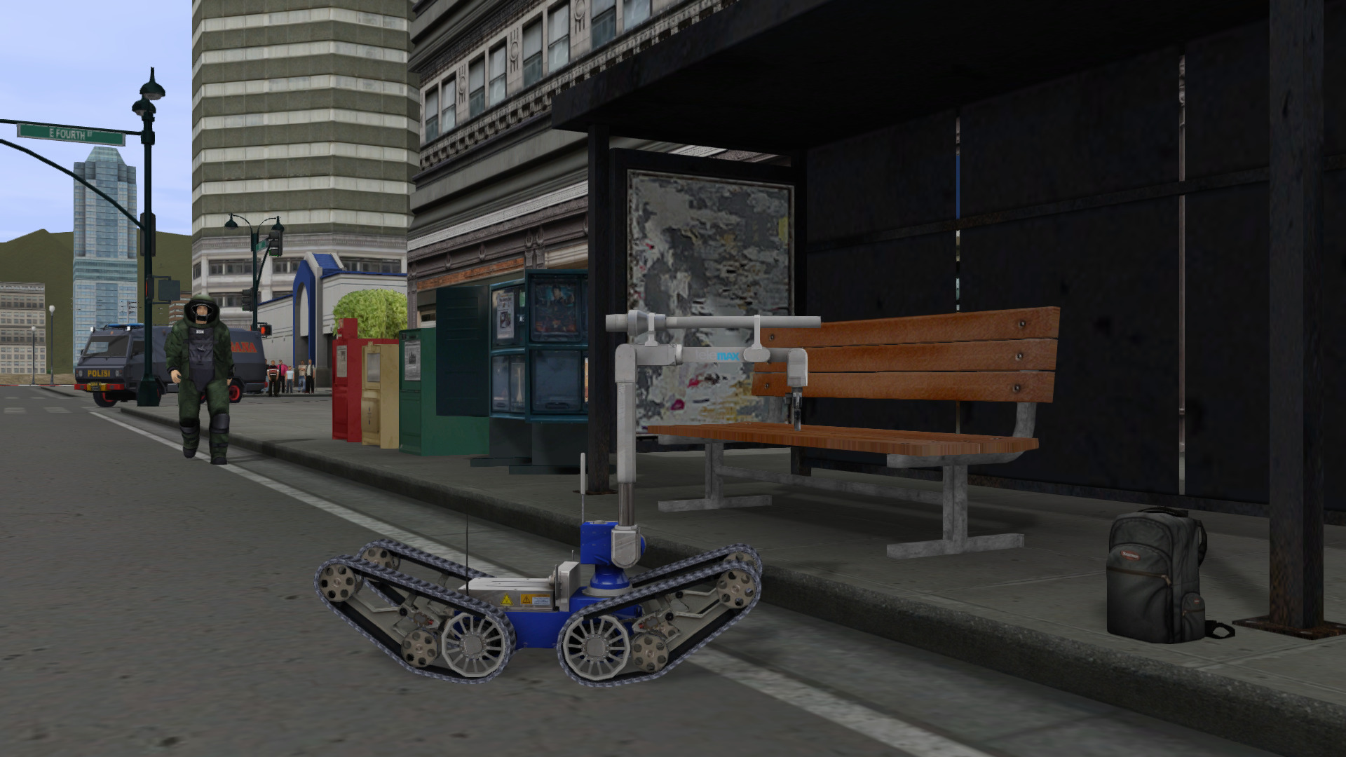 EOD Bot moving in closer to investigate a possible IED at a bus stop.